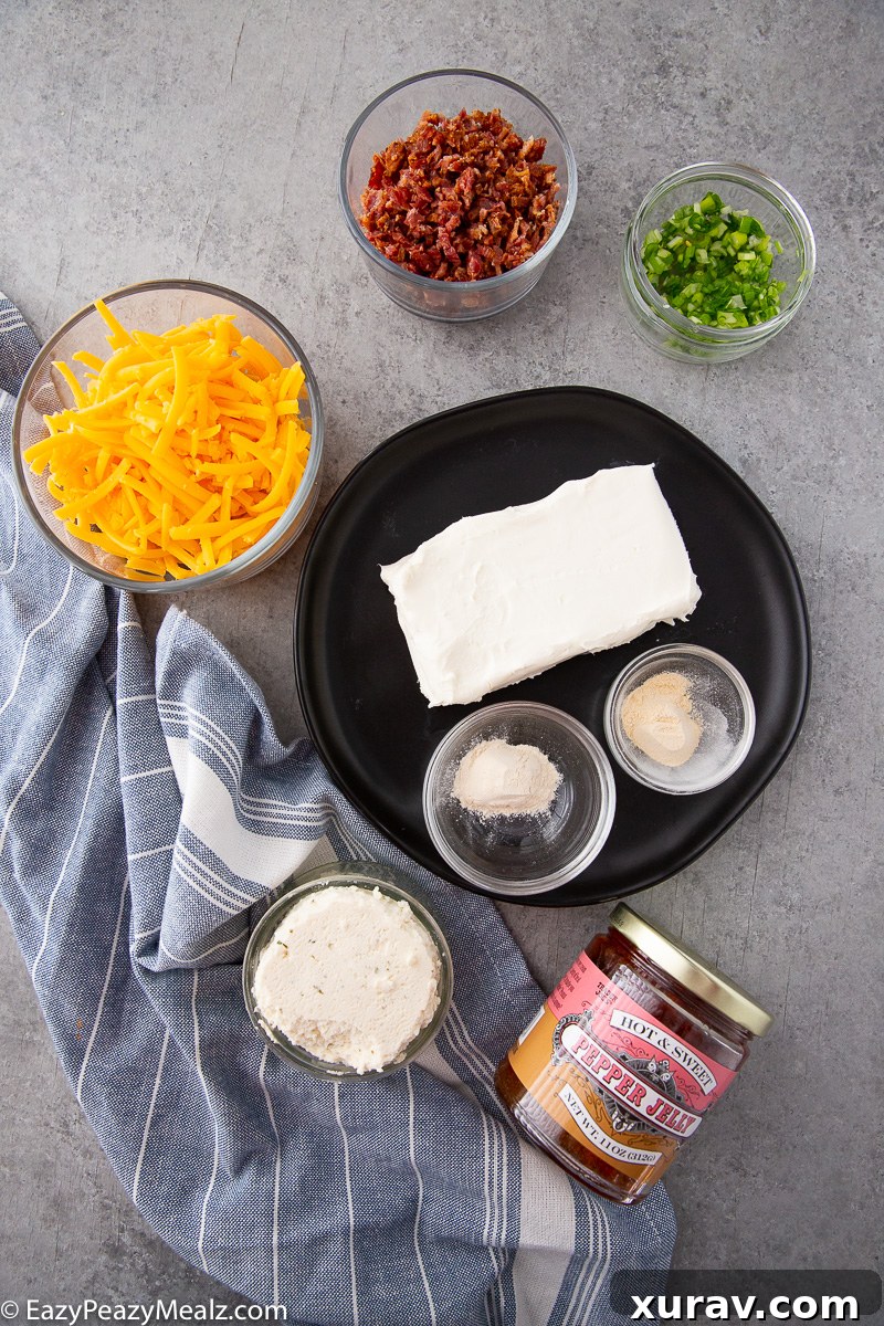 A selection of fresh ingredients including cream cheese, Boursin, cheddar, bacon, green onions, and garlic powder, ready to make the dip.
