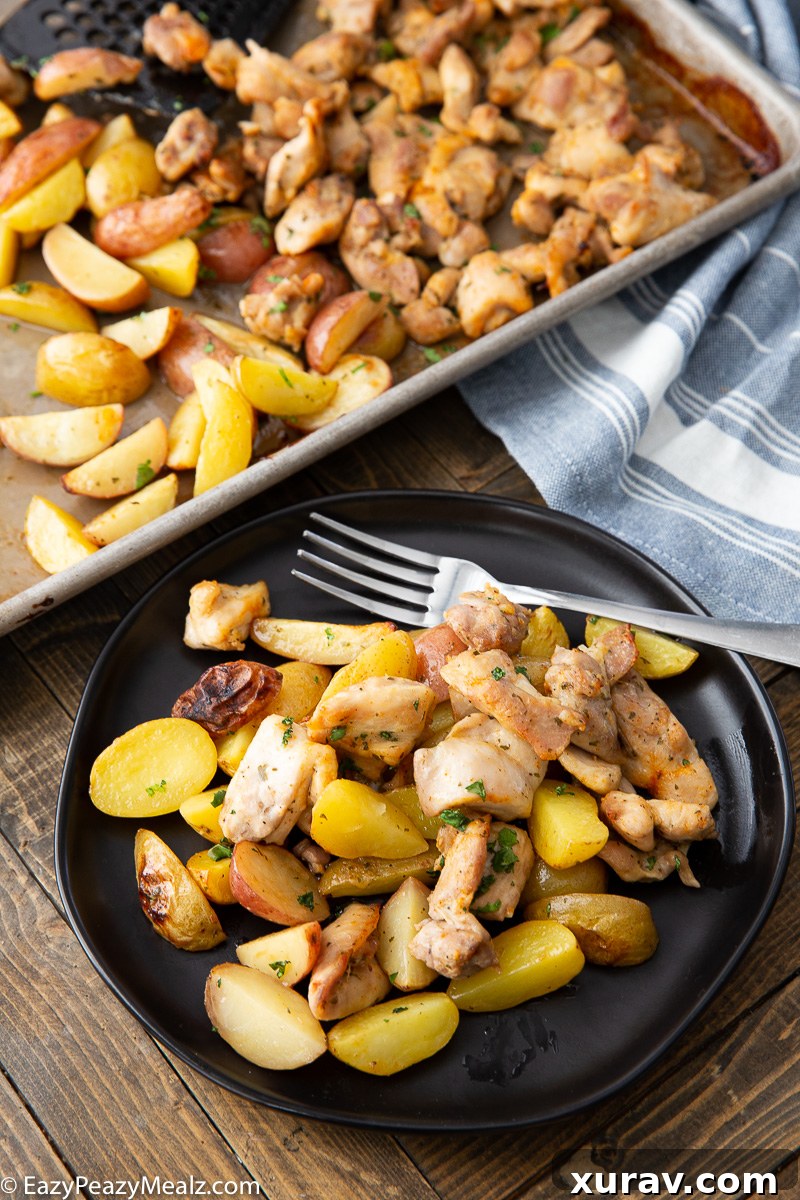 A plate of ranch chicken and potatoes, a simple sheet pan meal with fresh parsley