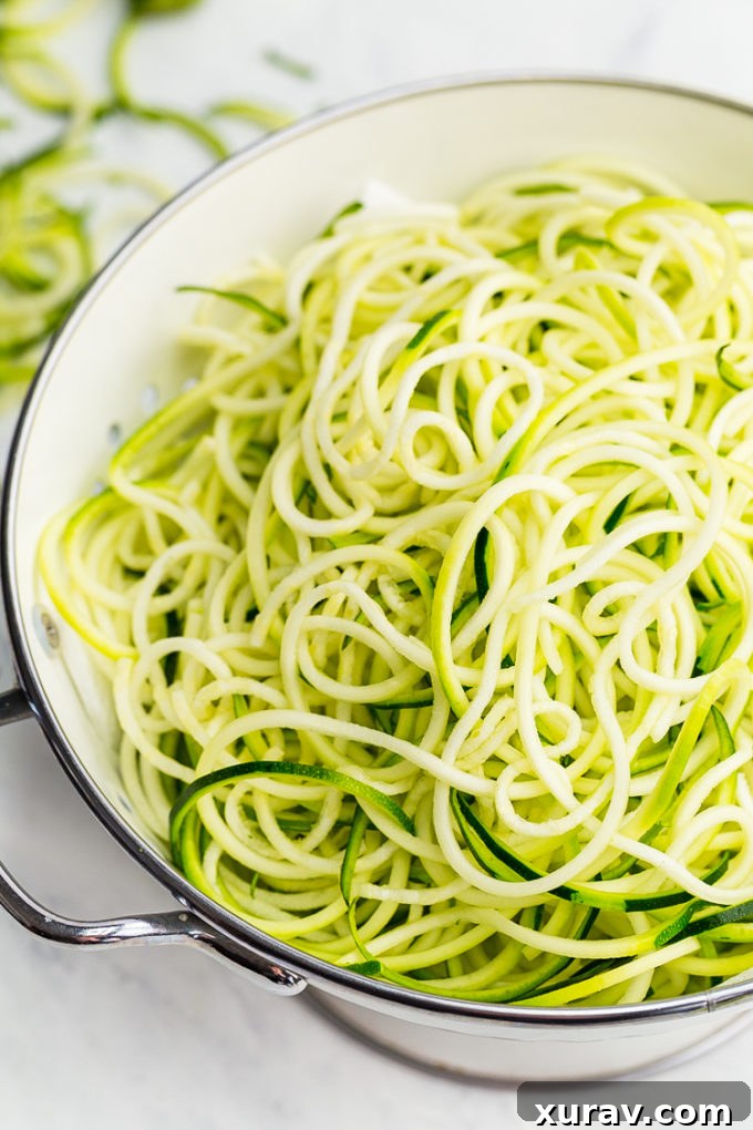 Close-up of freshly spiralized zucchini noodles, ready for cooking