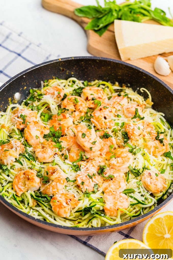 Delicious zucchini noodles with shrimp scampi, showcasing the sauce and fresh herbs