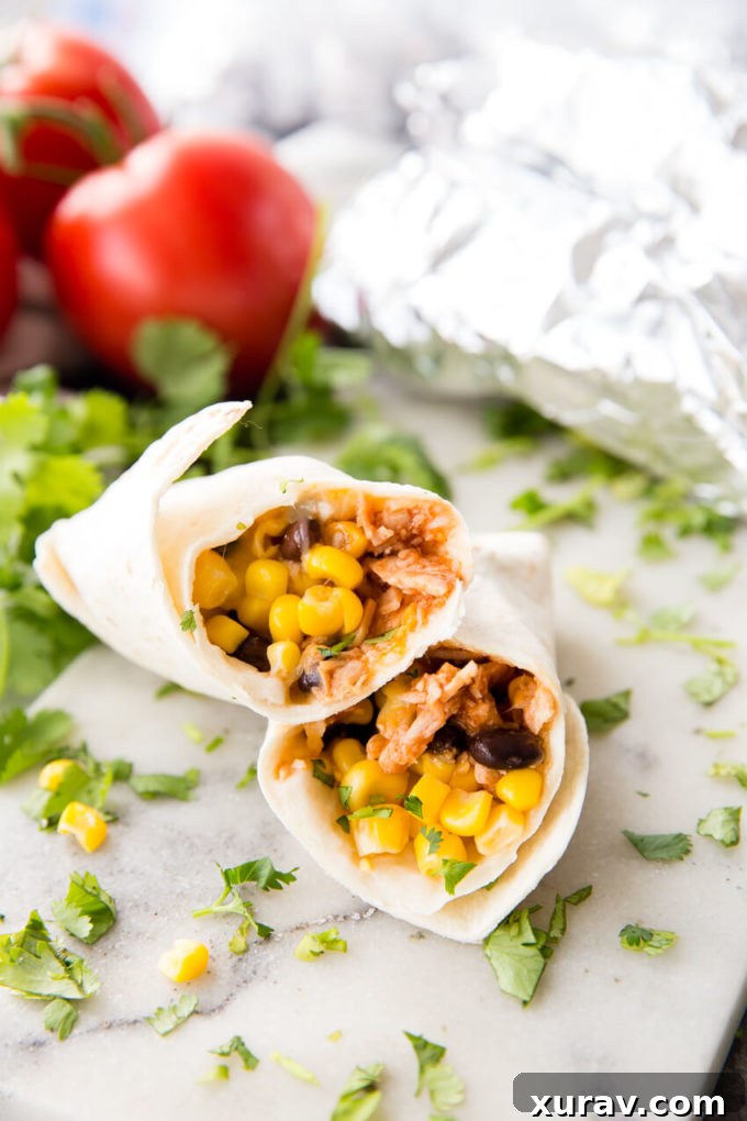 Flavorful BBQ Chicken Burritos with shredded chicken, BBQ sauce, beans, and corn, perfect for freezing.